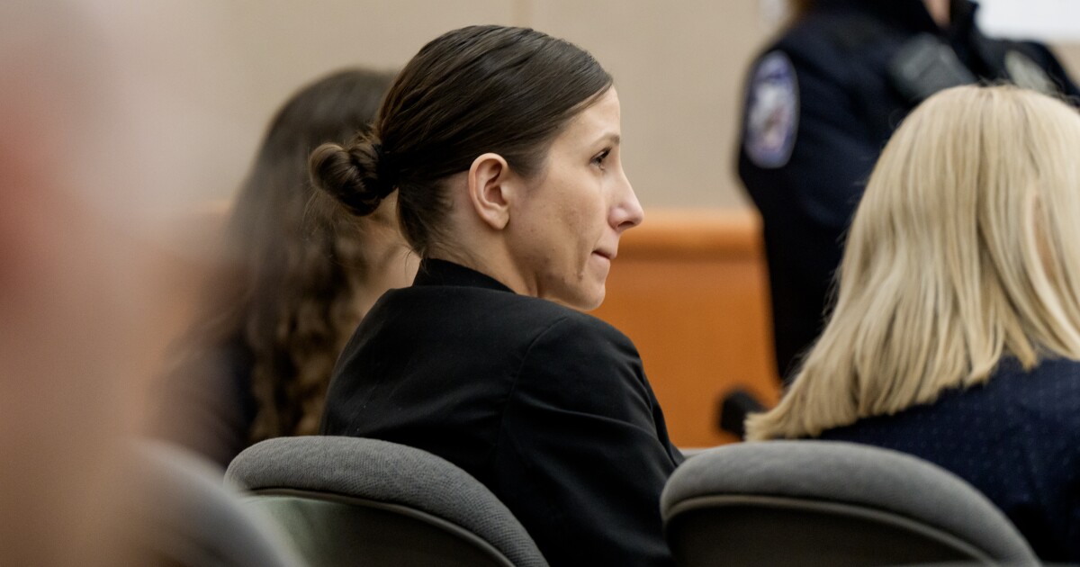 Courtroom scene showing multiple people seated, appears to be during trial proceedings