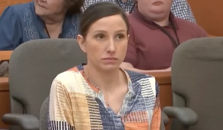 Portrait photo of woman in black turtleneck, looking upward