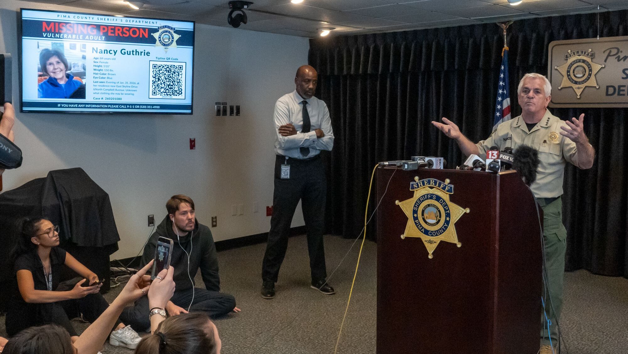 Official at podium with sheriff's department signage visible, appears to be law enforcement briefing