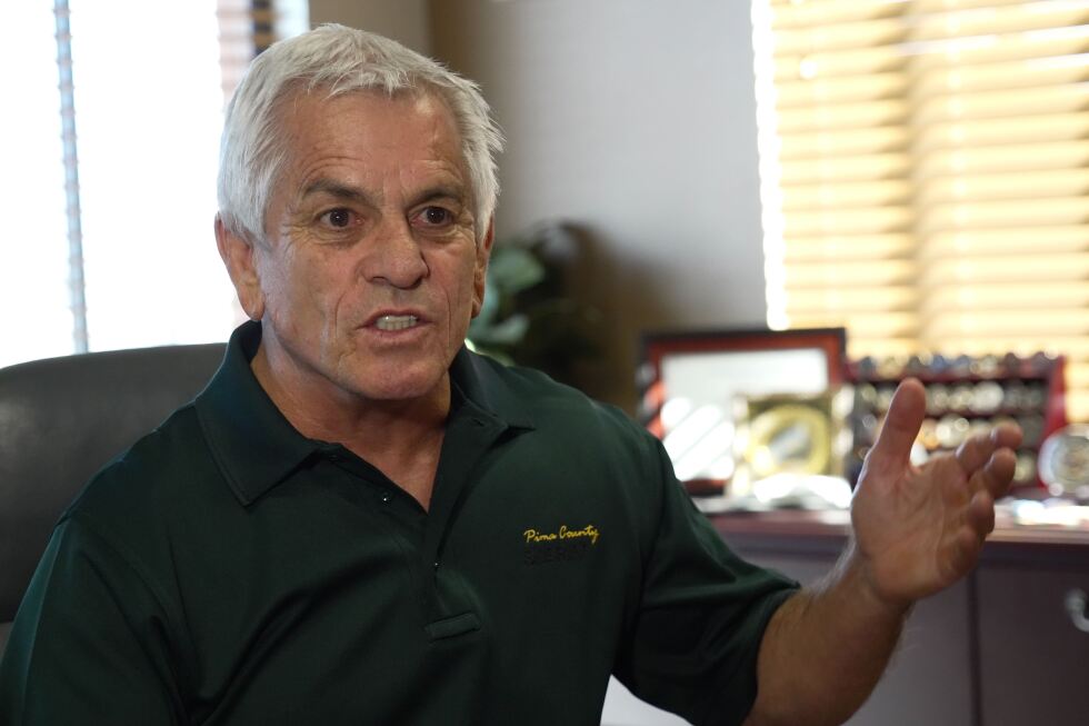Male individual in dark polo shirt, appears to be a mugshot or official photo